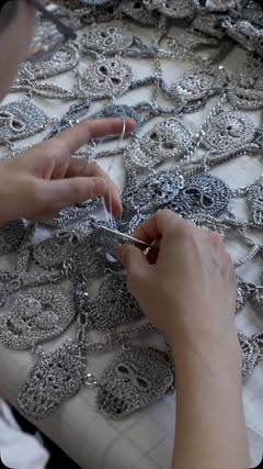 In the Atelier Look 29 Intricate metallic skull motifs crocheted by hand, embellished with crystal and pearl details. Sculptural archival headpiece in silver with electroformed roses and garnet beading, by master jewe…