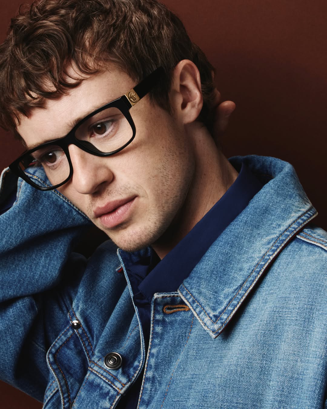 Versace Fall Winter 2026 eyewear — a study of mood and gesture, starring Joseph Quinn. Photographed by Heikki Kaski.