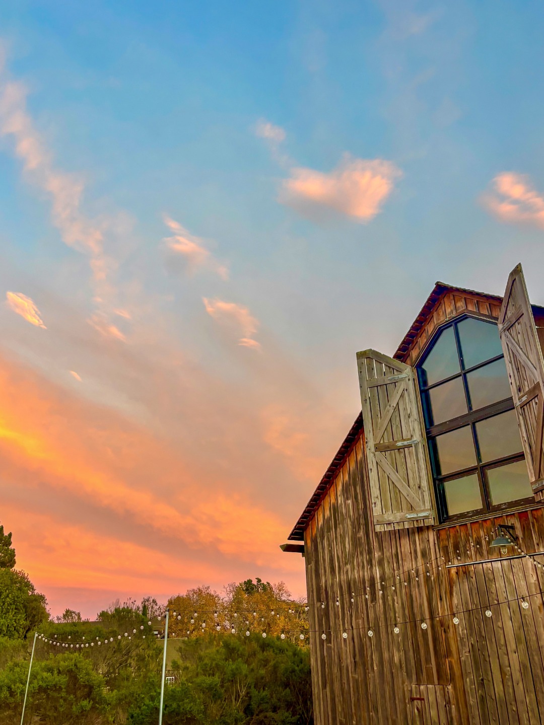 October sunsets at UC Santa Cruz 🌸 🌅 🌊 📸 Image descriptions: 1 - The Cowell Ranch Hay Barn with a vibrant sunset of orange and pink hues behind it. 2 - Two people sitting on a bench overlooking East Field with the…