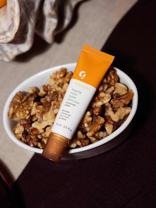 A little salty. A little sweet. A little toasty. Toasty Nuts Balm Dotcom is our holiday treat inspired by NYC’s nut carts. It goes on clear with a subtle copper shimmer and an ultra-rich texture that keep lips soft an…